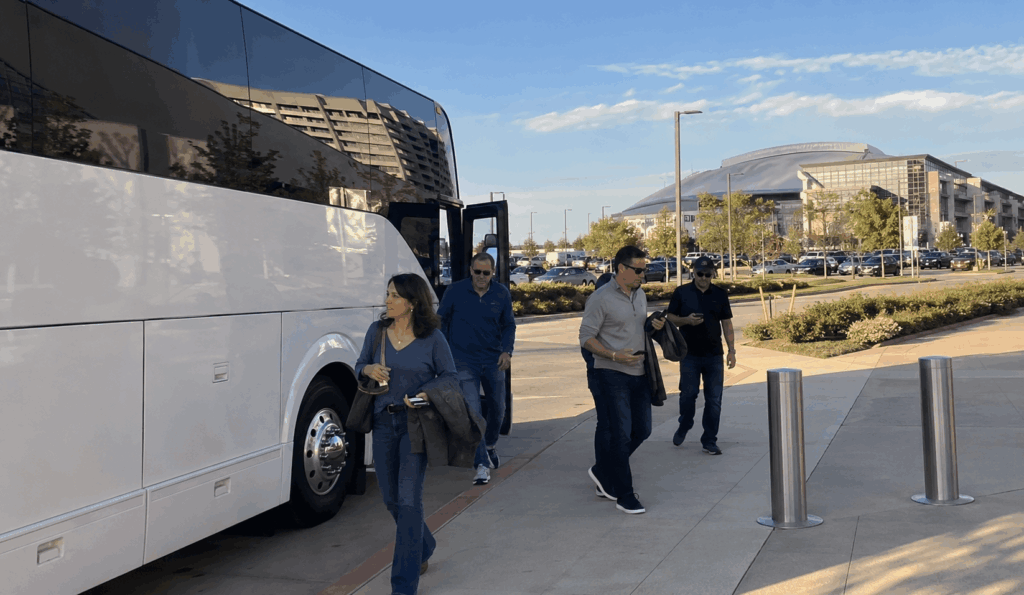 charter bus dropping off a group near the arlington entertainment district for a choctaw stadium event