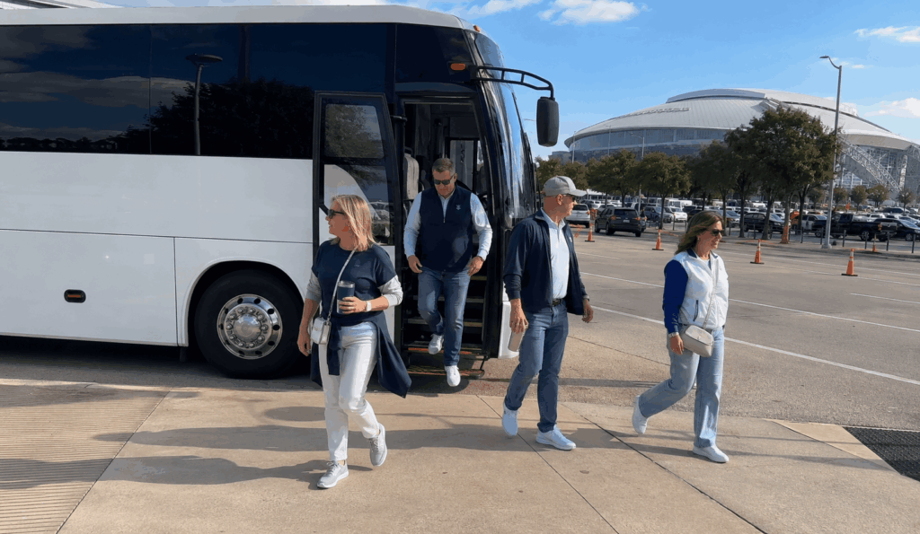 cowboys fans unloading tailgate gear from a charter bus near at&t stadium in arlington