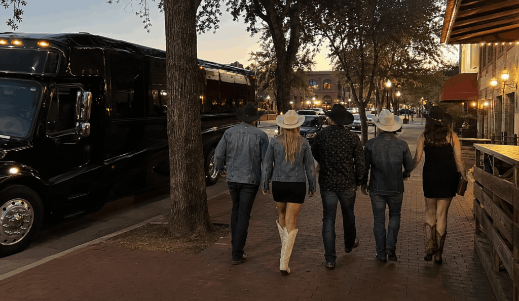 party bus dropping off a group near billy bob’s texas in the fort worth stockyards