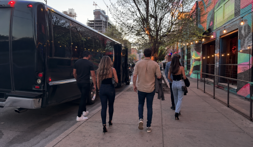 party bus dropping off a group for a night out in deep ellum, dallas