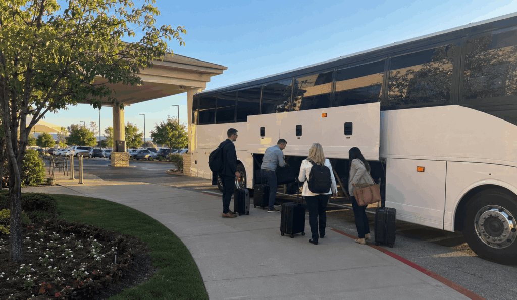 charter bus picking up a group in fort worth for a shuttle ride to dfw international airport