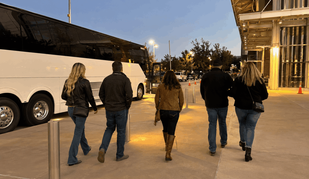 charter bus dropping off a group near Dickies Arena in Fort Worth before an event night