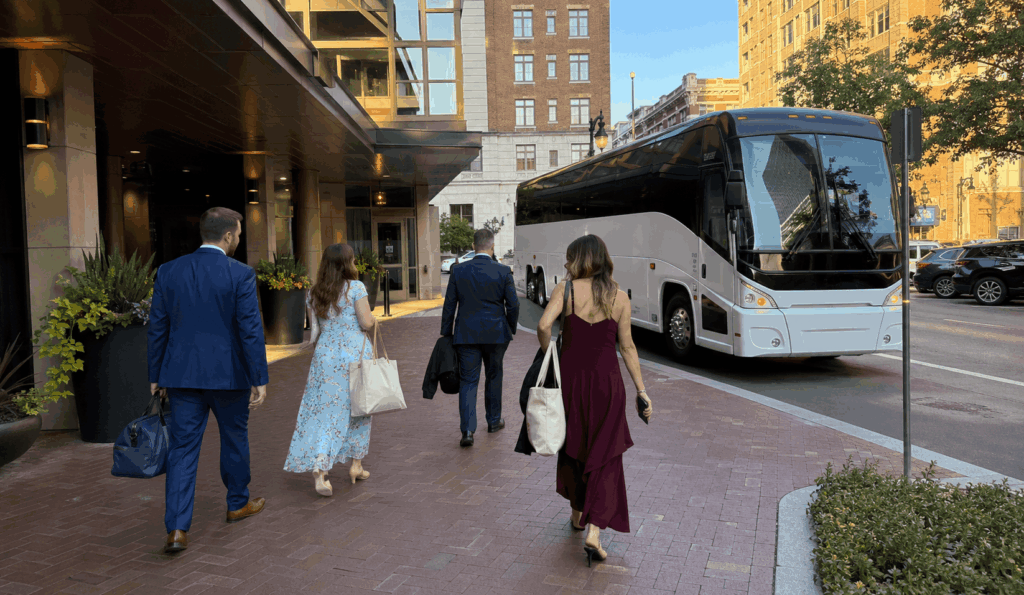 charter bus picking up wedding guests outside a downtown fort worth hotel for a hotel block shuttle