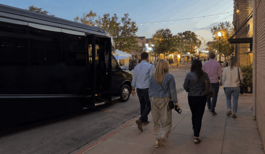 party bus dropping off a small group near Historic Main Street in Grapevine for GrapeFest festival shuttle service