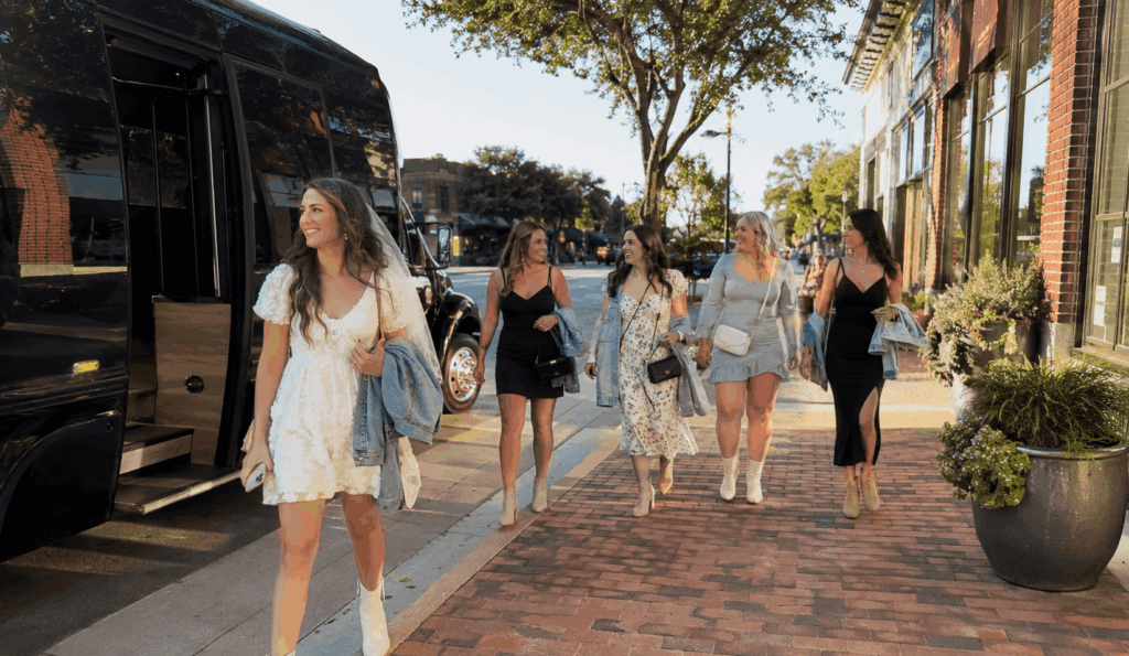 party bus dropping off a bachelorette group near historic main street in grapevine for a wine trail day