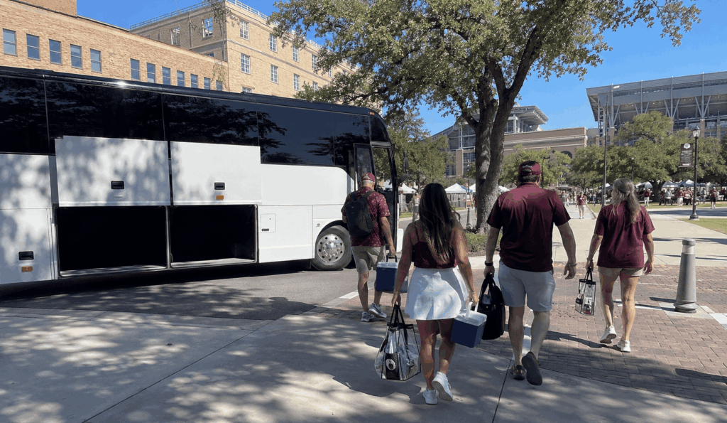 charter bus arriving near kyle field in college station for a texas a&m game day trip from fort worth