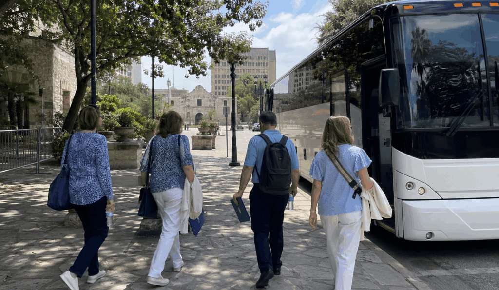 church group arriving by charter bus near the alamo in downtown san antonio for a group trip from fort worth