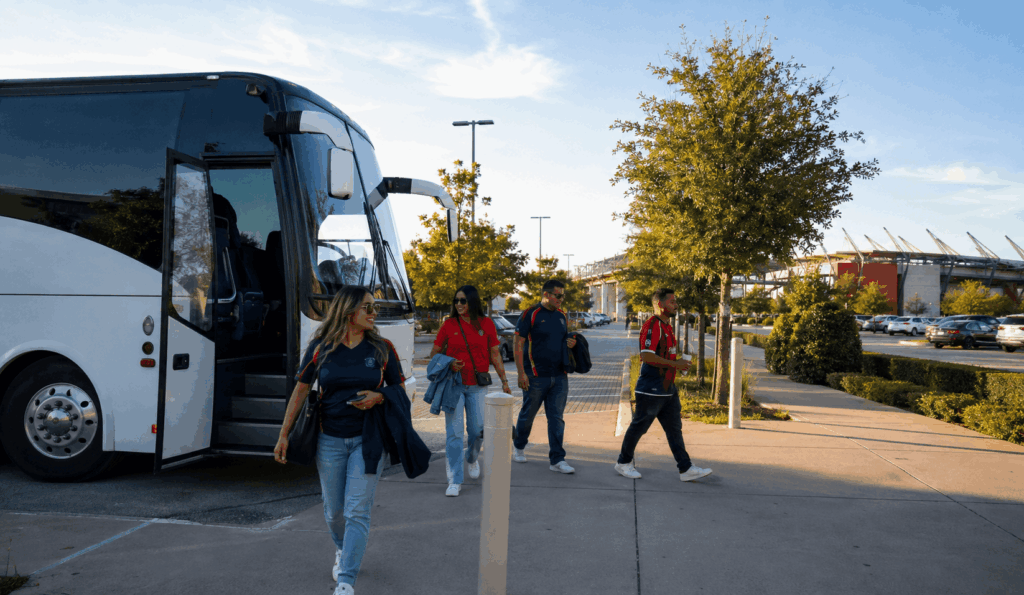 charter bus dropping off fc dallas fans near toyota stadium in frisco for a match day trip from fort worth